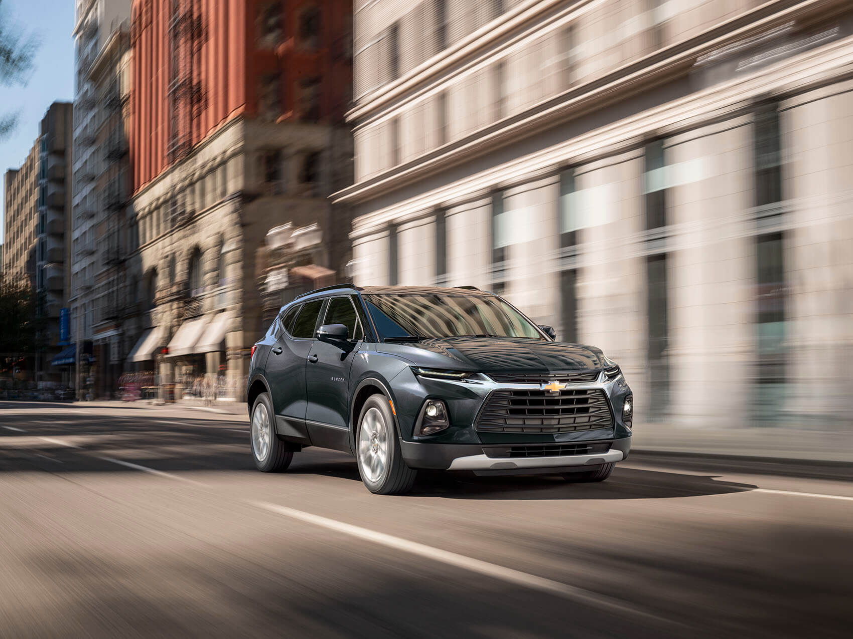 Dark blue Chevy Equinox driving on city street near New Rome OH
